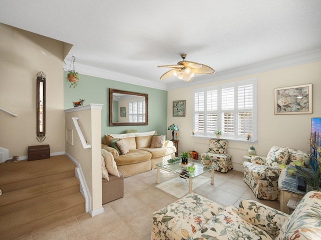 living area featuring a ceiling fan, crown molding, stairway, and tile patterned floors