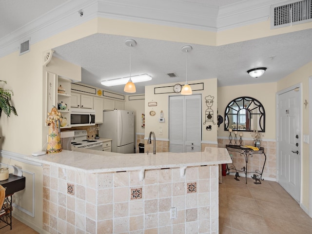 kitchen with open shelves, visible vents, light tile patterned flooring, a textured ceiling, and white appliances