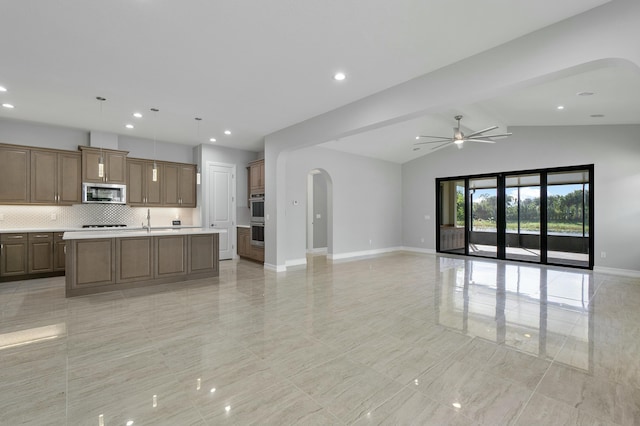 unfurnished living room with a ceiling fan, arched walkways, vaulted ceiling, and baseboards