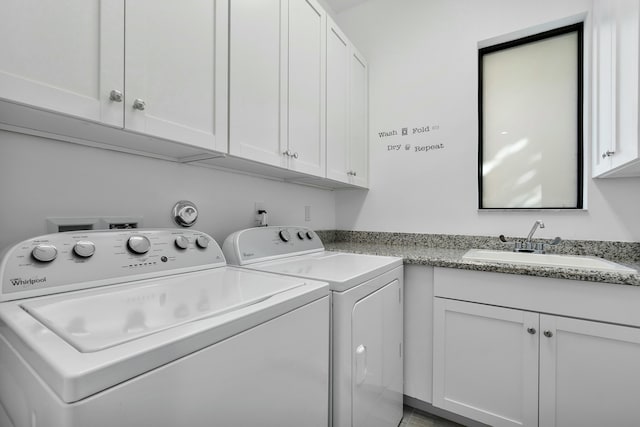 laundry area with a sink, cabinet space, and washer and dryer