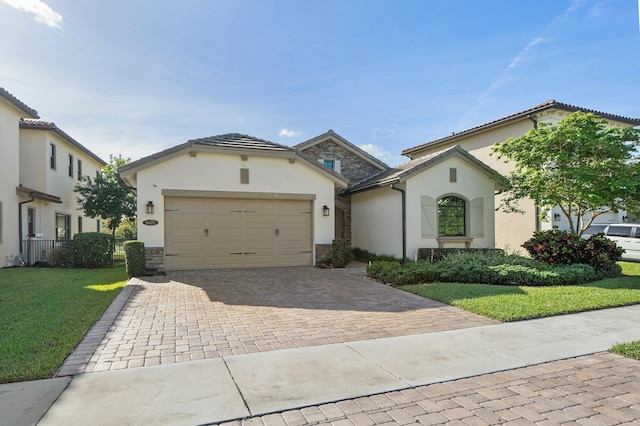 view of front facade with stone siding, decorative driveway, a garage, and stucco siding