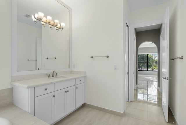 bathroom with baseboards, visible vents, tile patterned flooring, and vanity