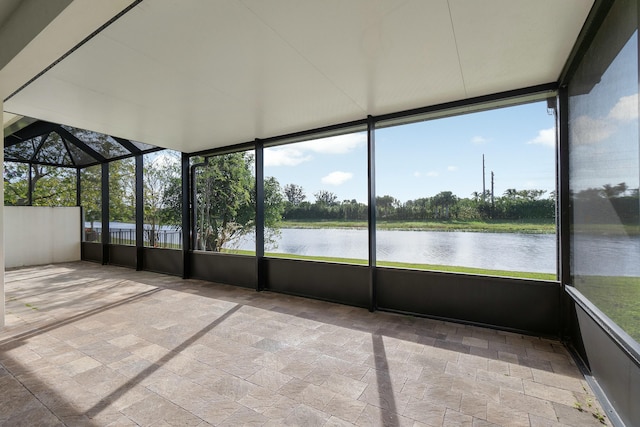 unfurnished sunroom with a wealth of natural light and a water view