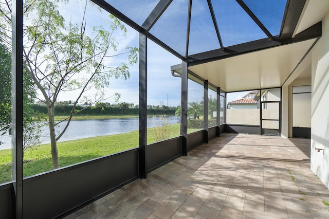 unfurnished sunroom with a water view