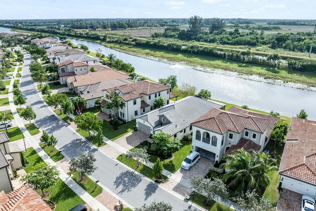 bird's eye view featuring a water view and a residential view