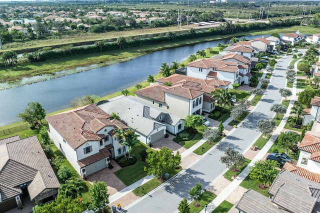 birds eye view of property with a water view and a residential view