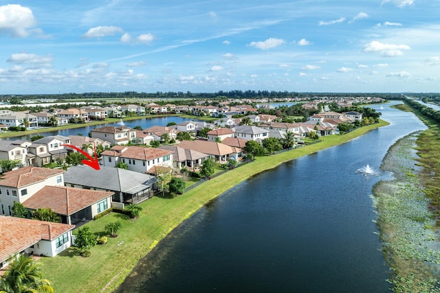 drone / aerial view featuring a water view and a residential view