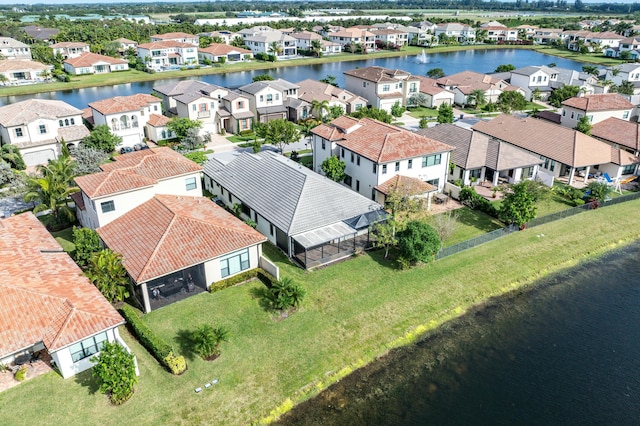 birds eye view of property with a water view and a residential view