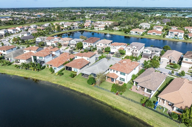 birds eye view of property with a water view and a residential view