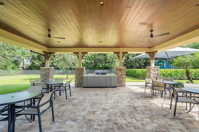 view of patio featuring outdoor dining space, fence, and ceiling fan