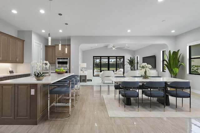 dining room featuring a ceiling fan, lofted ceiling, and recessed lighting