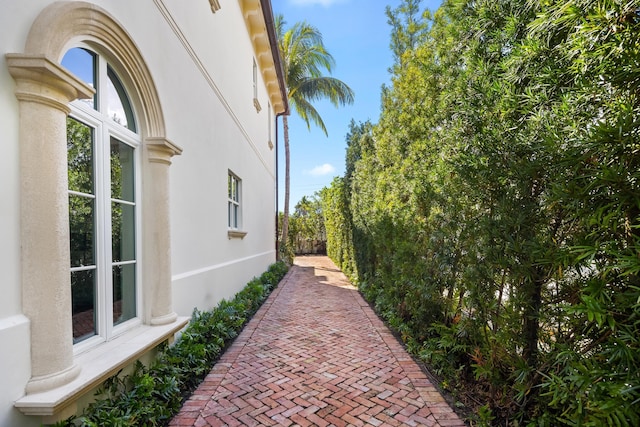 view of side of property featuring fence and stucco siding