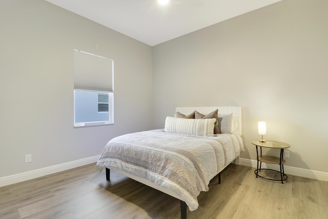 bedroom featuring baseboards and light wood-style floors