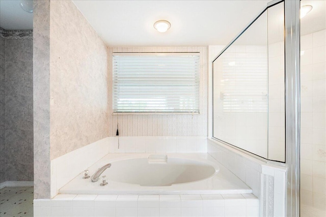 full bath with a tile shower and a garden tub