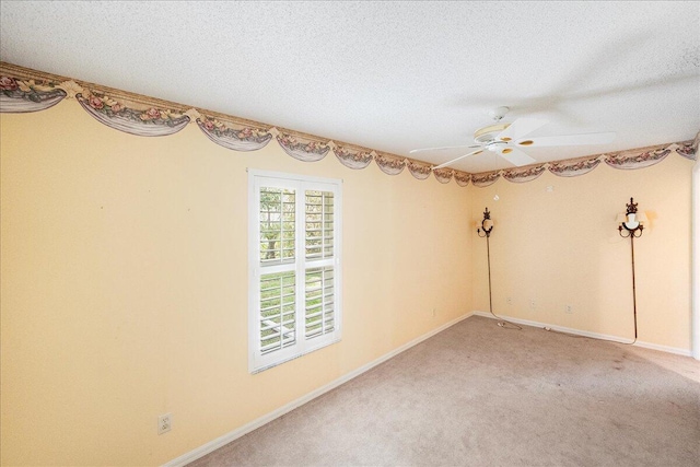 unfurnished room with a textured ceiling, ceiling fan, light carpet, and baseboards