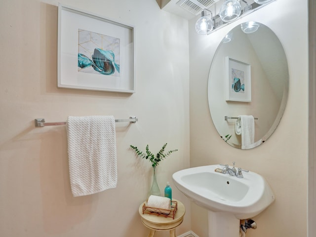 bathroom featuring visible vents and a sink