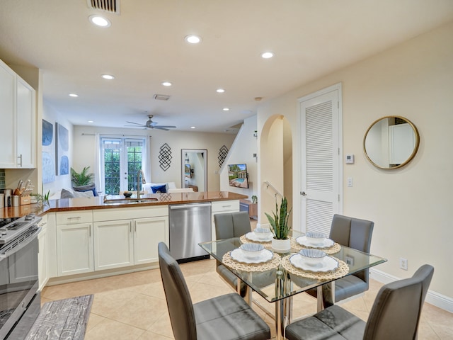 dining space featuring light tile patterned floors, arched walkways, visible vents, and recessed lighting