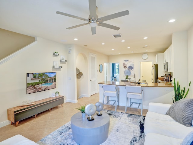 living room with light tile patterned floors, recessed lighting, a ceiling fan, baseboards, and visible vents