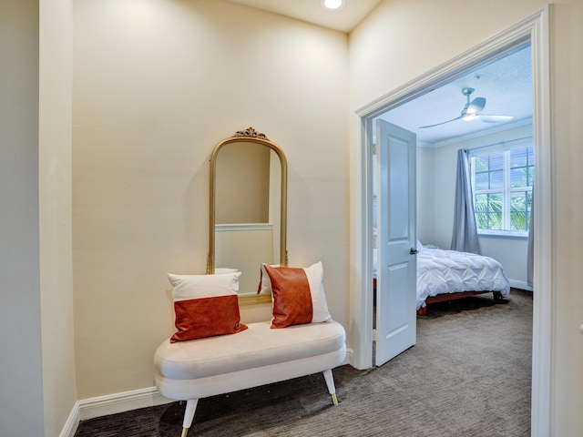 hallway featuring carpet floors and baseboards