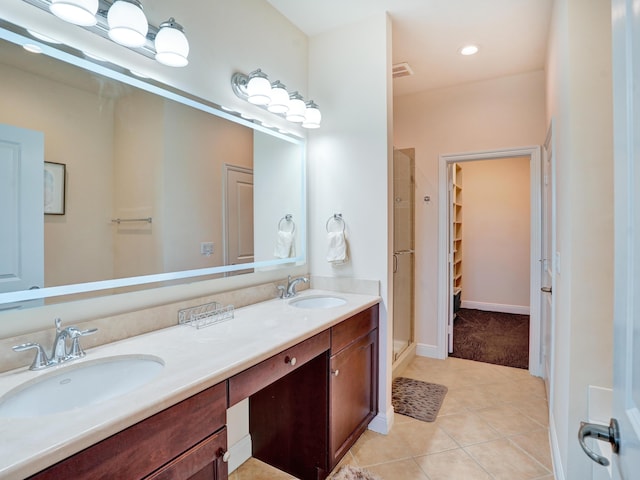 full bathroom with tile patterned flooring, a sink, a shower stall, and double vanity