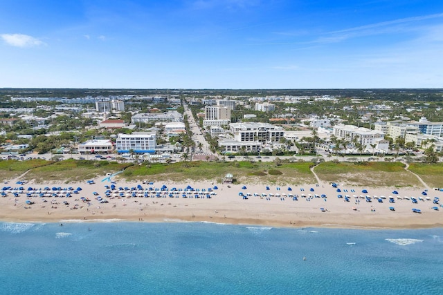 aerial view featuring a view of city, a water view, and a beach view