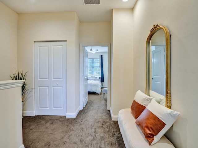 corridor featuring carpet, visible vents, and baseboards