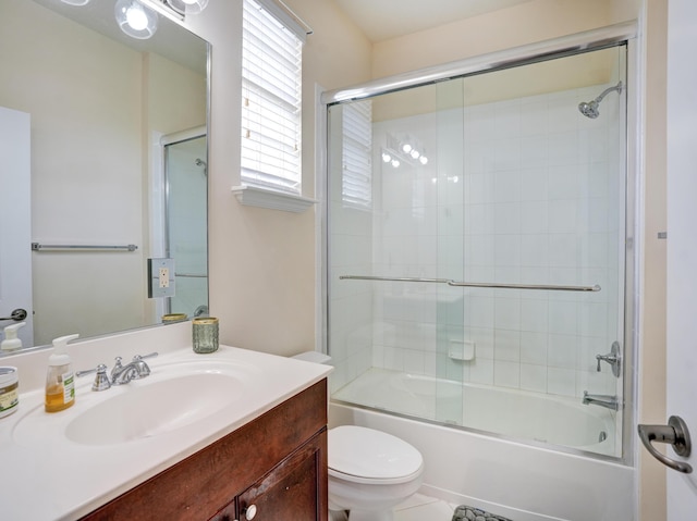 full bathroom with toilet, bath / shower combo with glass door, and vanity