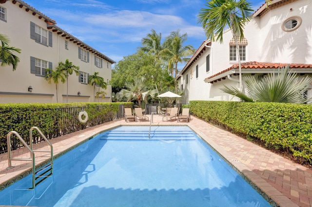 pool featuring a patio area and fence