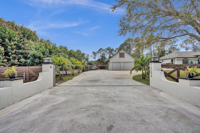 exterior space with a gated entry and concrete driveway