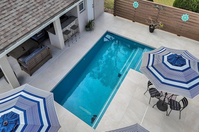 view of swimming pool with a patio area