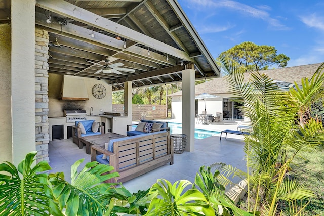 view of patio / terrace with an outdoor kitchen, a fenced in pool, a ceiling fan, fence, and outdoor lounge area