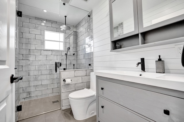 full bathroom with a stall shower, vanity, and toilet