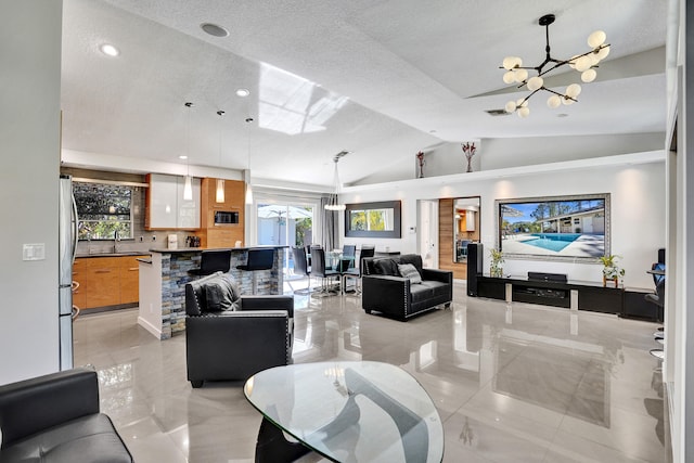 living room with vaulted ceiling, visible vents, a wealth of natural light, and a notable chandelier