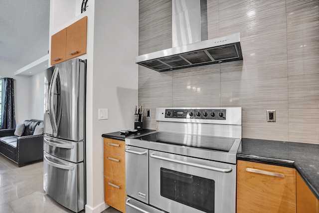 kitchen featuring light tile patterned floors, stainless steel appliances, dark countertops, backsplash, and wall chimney exhaust hood