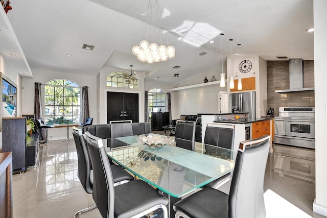 dining area featuring lofted ceiling and visible vents