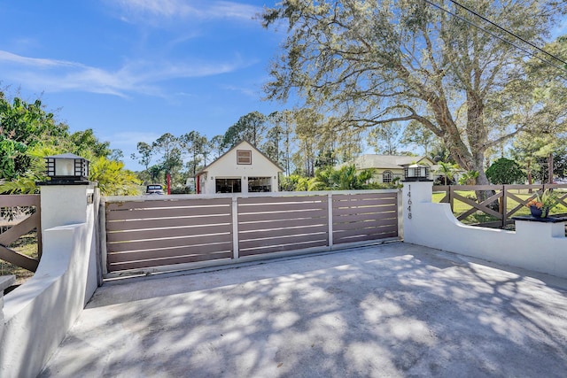 view of gate featuring a fenced front yard