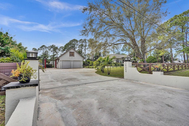 exterior space featuring a garage and a fenced front yard