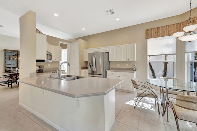 kitchen with a wealth of natural light, visible vents, appliances with stainless steel finishes, and a sink