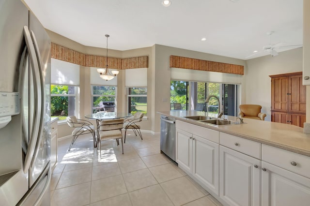 kitchen featuring a wealth of natural light, appliances with stainless steel finishes, light countertops, and a sink