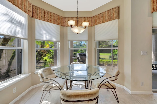 dining space with a notable chandelier, baseboards, and light tile patterned floors