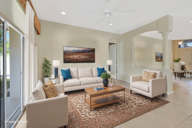 living room with a ceiling fan, recessed lighting, light tile patterned flooring, and ornate columns