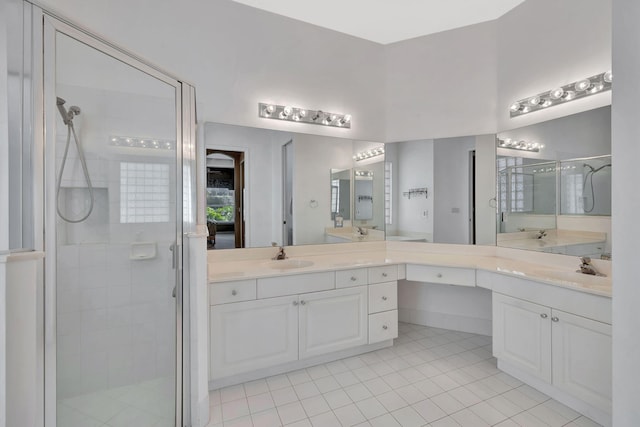 bathroom with a stall shower, tile patterned flooring, and vanity