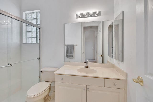 full bathroom with toilet, a shower stall, and vanity