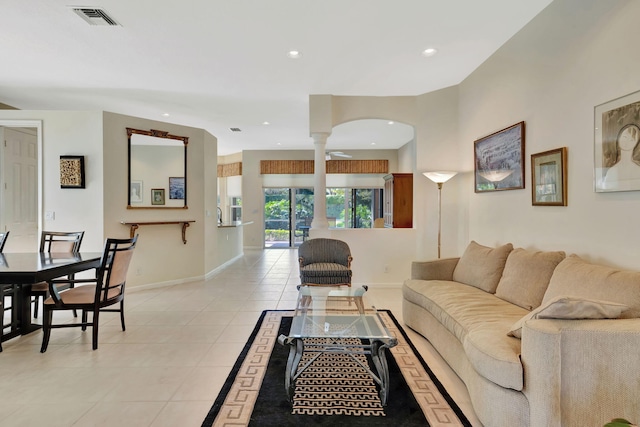 living area featuring recessed lighting, ornate columns, visible vents, light tile patterned flooring, and baseboards