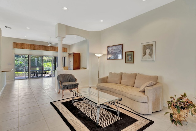 living area with light tile patterned floors, recessed lighting, baseboards, and ornate columns