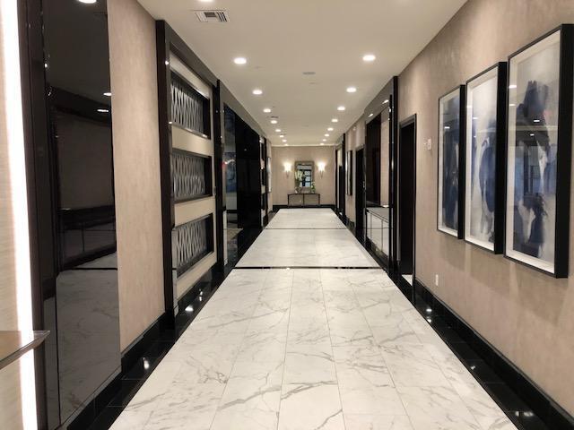 hallway featuring recessed lighting, marble finish floor, and visible vents