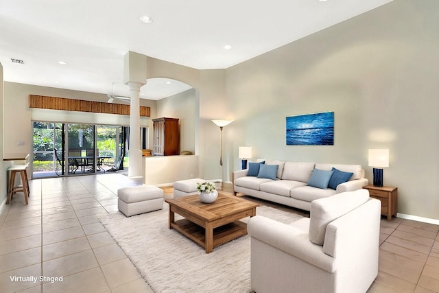 living area with ornate columns, recessed lighting, visible vents, and baseboards