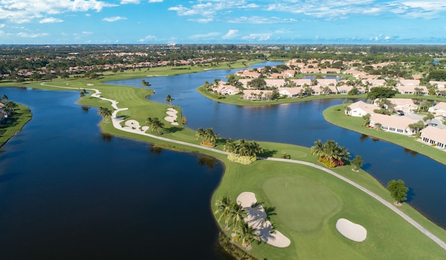 aerial view with golf course view, a water view, and a residential view