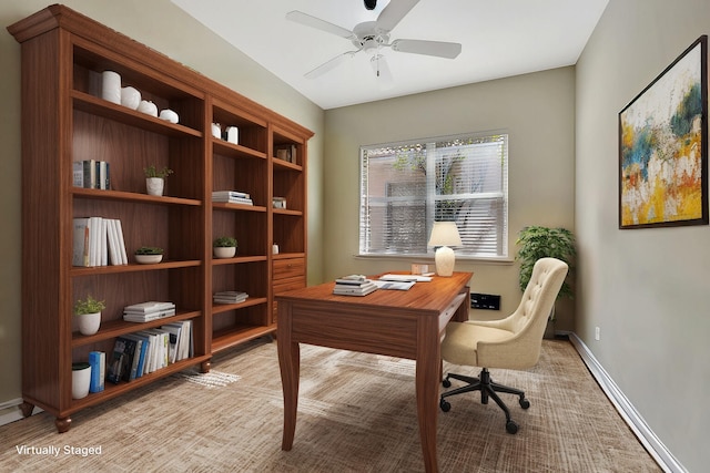 office area with a ceiling fan and baseboards