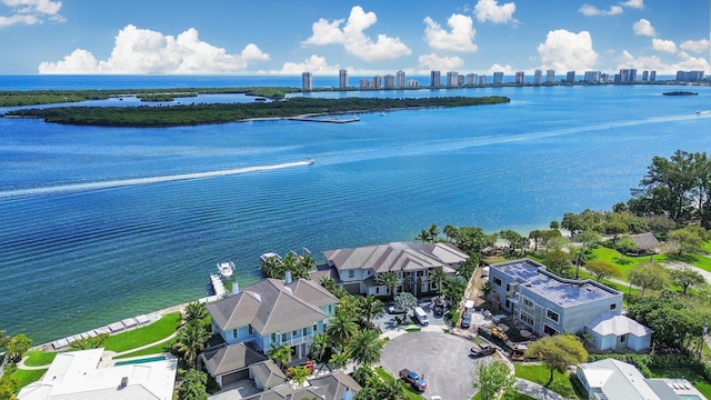 birds eye view of property featuring a water view and a city view